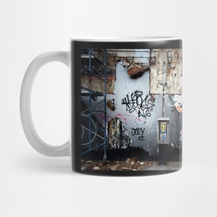 Decaying urban brick wall with graffiti paint and street art in New York City Mug